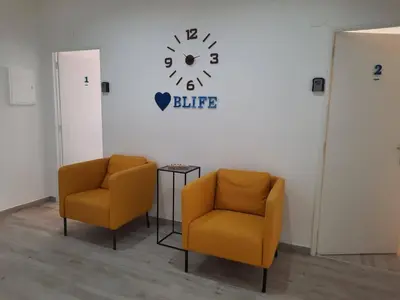 two chairs in a room with a clock on the wall at Blife Antonya private rooms at 3rd floor in Faro
