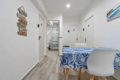 a dining room with a blue and white table and chairs at Blife Antonya private rooms at 3rd floor in Faro