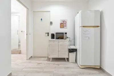 a white refrigerator in a room with a microwave at Blife Antonya private rooms at 3rd floor in Faro