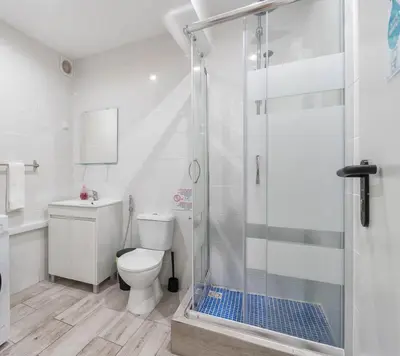 a bathroom with a shower with a toilet and a sink at Blife Antonya private rooms at 3rd floor in Faro