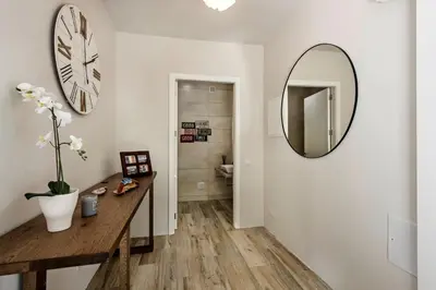 a bathroom with a clock on the wall and a mirror at Dazzling Almancil Villa Villa Magorian 4 Bedrooms Spacious Furnished in Almancil