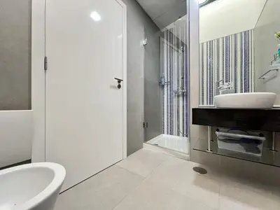 a white bathroom with a sink and a shower at Vilamoura Club Villa 3 With Pool by Homing in Vilamoura