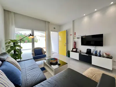 a living room with a couch and a tv at Vilamoura Club Villa 3 With Pool by Homing in Vilamoura