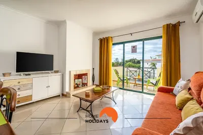 a living room with a couch and a tv at #243 Jardins de Santa Eulália H23 by Home Holidays in Albufeira