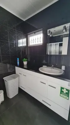 a bathroom with a white sink and a mirror at Apartamento T1 centro Albufeira in Albufeira