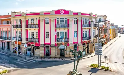 a pink and white building on a city street at Arts by Loulé - Alojamento de Charme in Loulé