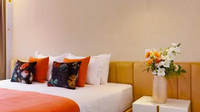 a bedroom with a bed with a vase of flowers at Arts by Loulé - Alojamento de Charme in Loulé