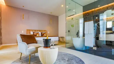 a living room with a chair and a bed and a tub at Arts by Loulé - Alojamento de Charme in Loulé