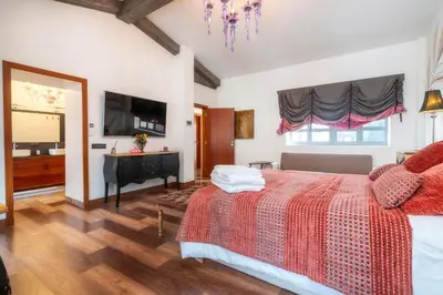 a bedroom with a bed and a desk and a television at Oakmoon House in Faro