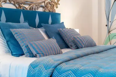 a blue and white bed with blue pillows on it at Oakmoon House in Faro