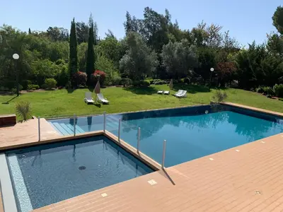 a swimming pool on top of a wooden deck at Vilamoura Club Villa 2 With Pool by Homing in Vilamoura