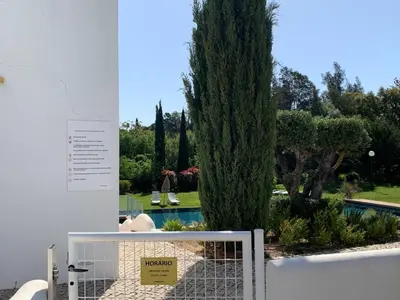 a sign on a fence in front of a tree at Vilamoura Club Villa 2 With Pool by Homing in Vilamoura