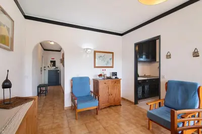 a living room with two blue chairs and a table at T1 em Vilamoura - Parque Mourabel in Vilamoura