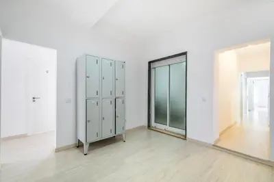 a room with white walls and a mirror at GrowIN Stay Mercado in Faro
