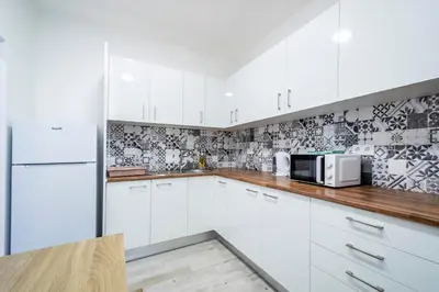 a kitchen with white cabinets and a microwave at GrowIN Stay Mercado in Faro