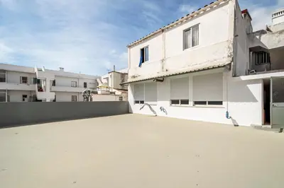 an empty parking lot in front of a building at GrowIN Stay Mercado in Faro