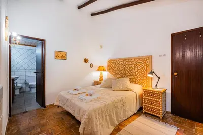 a bedroom with a bed and a bathroom at Villa Alice by Algarve Vacation in Albufeira