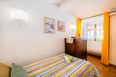 a bedroom with a bed and a dresser and a window at Villa Alice by Algarve Vacation in Albufeira