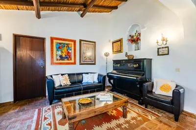 a living room with a piano and a couch at Villa Alice by Algarve Vacation in Albufeira