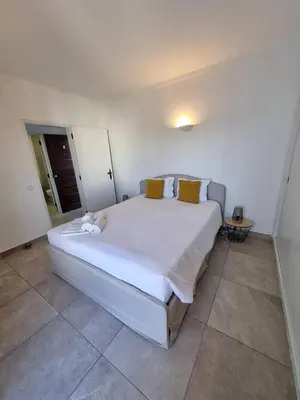 a bedroom with a large white bed with yellow pillows at BelChoro SeaLine in Albufeira