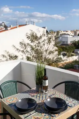 a table with two plates and a bottle of wine at BelChoro SeaLine in Albufeira