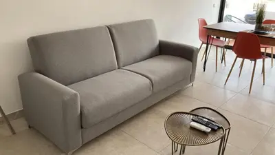 a couch in a living room with a table and chairs at BelChoro SeaLine in Albufeira