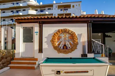 a pool table in front of a building at Ourabay Hotel Apartamento - Art & Holidays in Albufeira