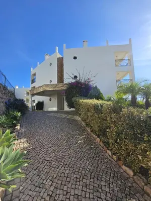 a brick walkway next to a white building at Colina do Atlântico 203 in Albufeira