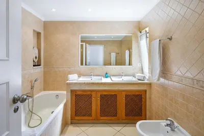 a bathroom with a tub and a sink and a bath tub at Villa Carlos in Loulé
