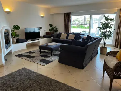 a living room with a couch and a tv at Villa Carlos in Loulé