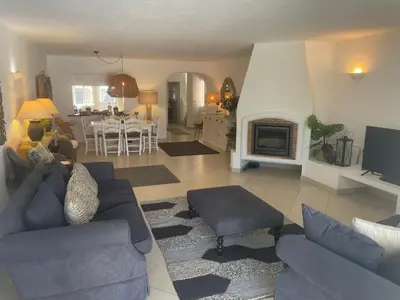 a living room with a couch and a fireplace at Villa Carlos in Loulé