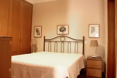 a bedroom with a bed and two pictures on the wall at Jardins Vale de Parra in Albufeira