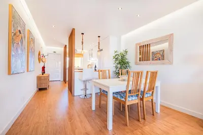 a kitchen and dining room with a table and chairs at Jardins Vale de Parra in Albufeira
