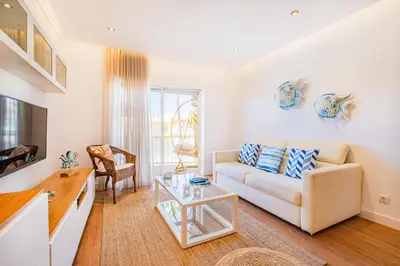 a living room with a couch and a table at Jardins Vale de Parra in Albufeira