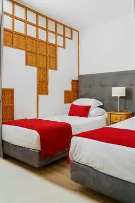a room with a bed with a plate with ducks on it at Luna Hotel da Oura in Albufeira