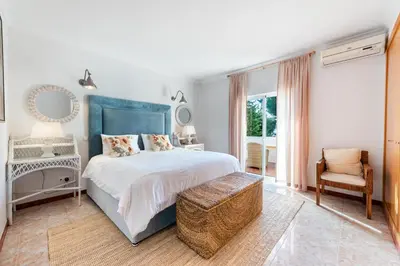 a bedroom with a large bed and a chair at Villa Lis in Galé