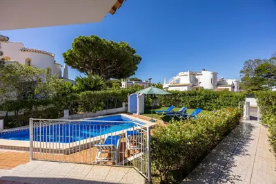 a shopping cart is next to a swimming pool at Villa Lis in Galé