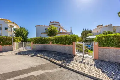 a fence in front of a building with trees at Villa Lis in Galé