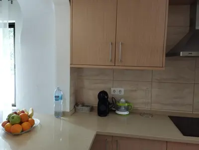 a kitchen with a bowl of fruit on a counter at Apartamento São Rafael Holidays in Albufeira