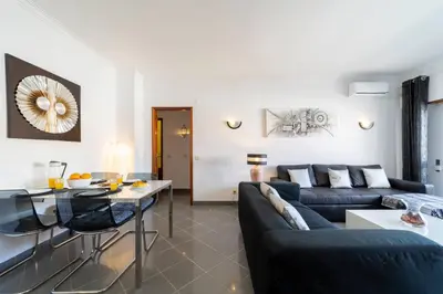 a living room with a couch and a table at Garnero Apartment by HelloVacations in Albufeira