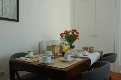 a table with cups and saucers on it at Casas Adentro in Faro