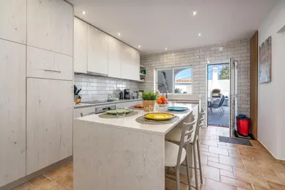 a kitchen with a large island in a room at Casa da Amélia in Albufeira