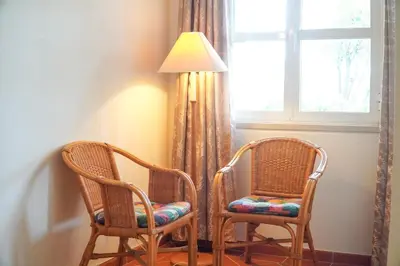 two chairs and a lamp next to a window at Villa Lydika I in Albufeira
