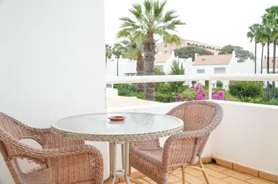 a table and chairs on a balcony with a table at Villa Lydika I in Albufeira