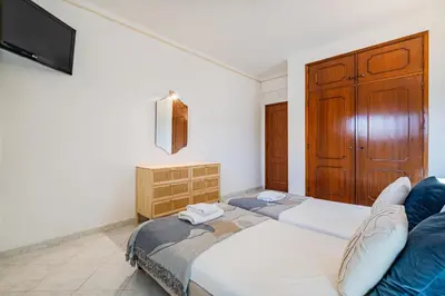 an apartment with a swimming pool in front of a building at Blue Wave Apartment in Albufeira