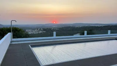 a view of the sunset from a balcony of a house at villagoldra rentals - Luxury and Family Villa in Goldra de Baixo