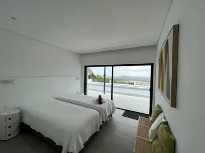 two beds in a bedroom with a large window at villagoldra rentals - Luxury and Family Villa in Goldra de Baixo
