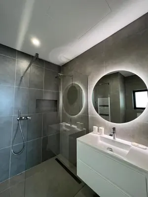 a bathroom with a sink and a shower and a mirror at villagoldra rentals - Luxury and Family Villa in Goldra de Baixo