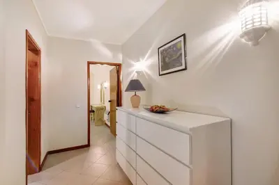 a hallway with a white dresser and a mirror at Bela Vista House T2 in Albufeira