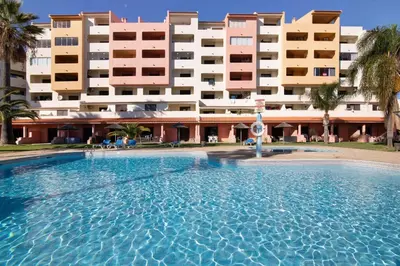 a large swimming pool in front of a building at Bela Vista House T2 in Albufeira